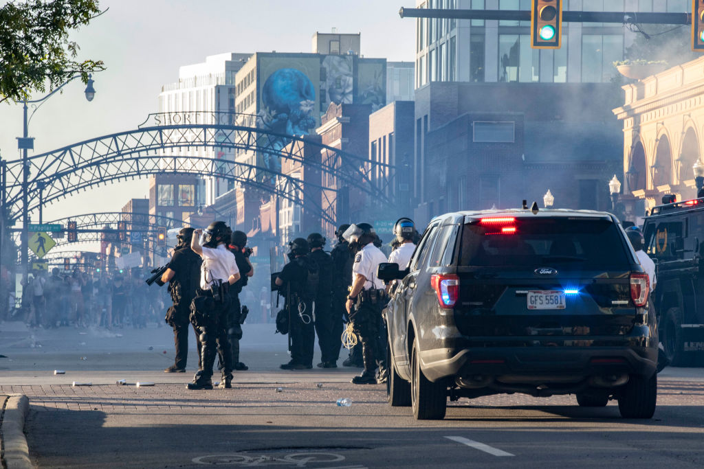 Columbus Police and SWAT officers fire tear gas canisters to...