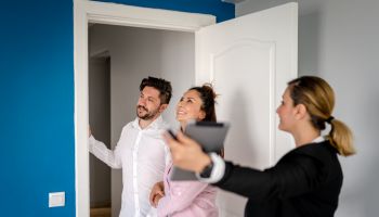 Real estate agent showing a property to a happy family