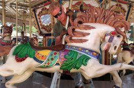 Jamie Dotson, a worker with Pugh Shows of Lancaster, Ohio, mounted √¨Elvis√Æ , the big-haired horse, onto a carousel near the grandstand onWednesday. The carousel features many fanciful characters, including Hercules the cat, a sea dragon, a rabbit